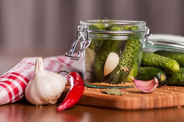 cucumbers with mustard seeds in a jar